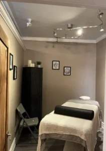 Massage therapy bed with clean linens at CWR Health Clinics.