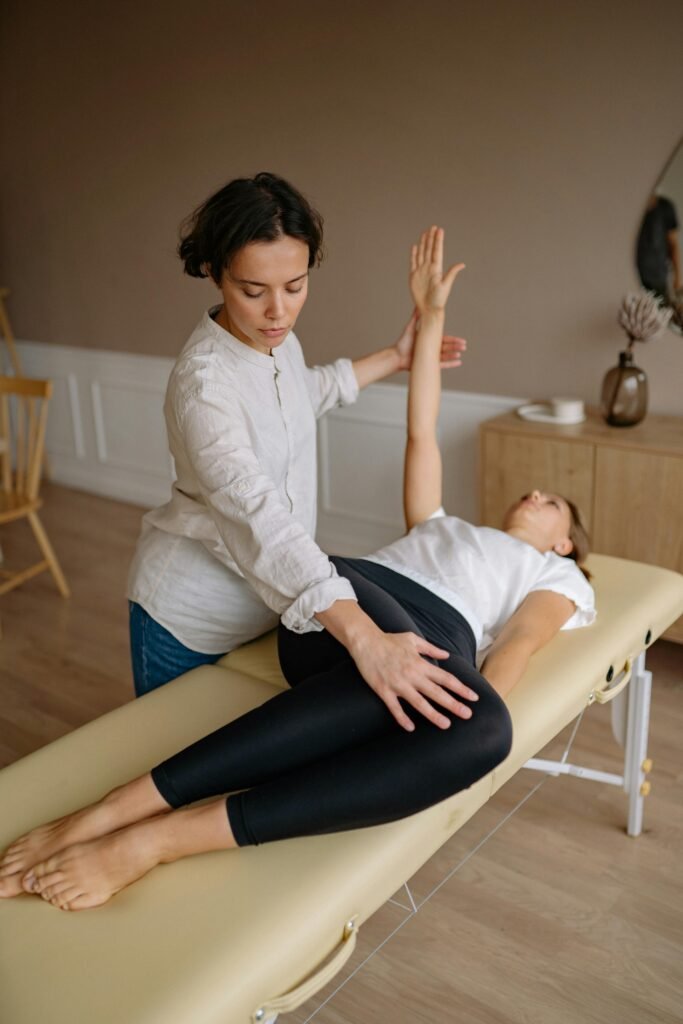 pexels-photo-5793918-5793918 Physiotherapist aids woman with therapeutic exercises indoors.